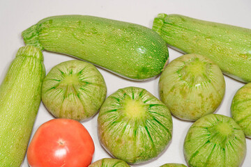 Vegetables with light background, tomato and zucchini