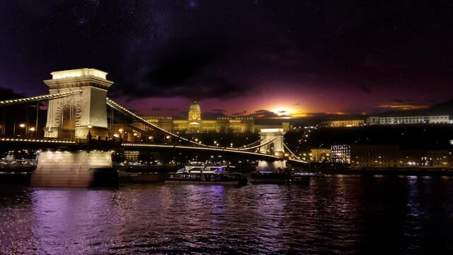 Spectacular night view over the Danube, past the Chain Bridge towards Buda Castle with a dramatic night sky