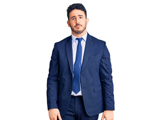 Young hispanic man wearing business clothes with serious expression on face. simple and natural looking at the camera.