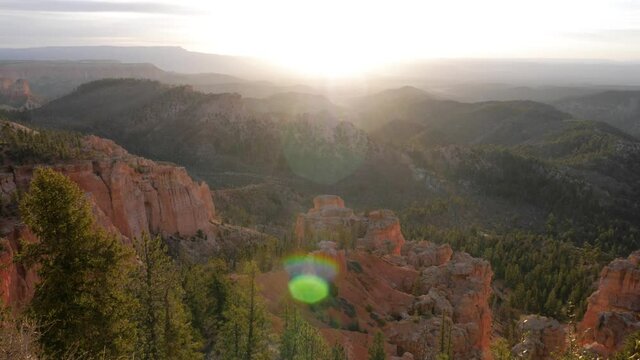Slow motion shot of sun shining in Bryce Canyon National Park in Utah, USA camera tilting up