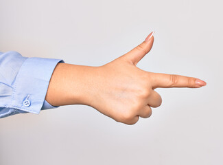 Hand of caucasian young businesswoman doing gun symbol pointing with finger over isolated white background