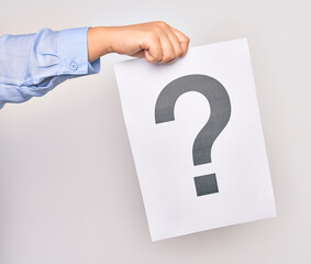 Hand of caucasian young woman holding paper with question mark symbol over isolated white background