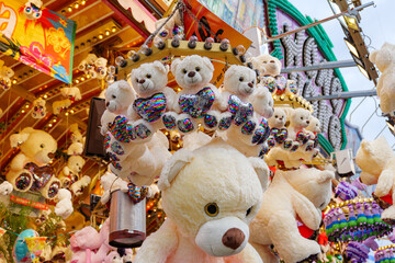 Selected focus view at hanging bear dolls over souvenir stall and shop at Rheinkirmes funfair...