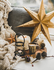 Christmas festive holiday mood composition with coffee in rustic cup, candles and decorative toys...