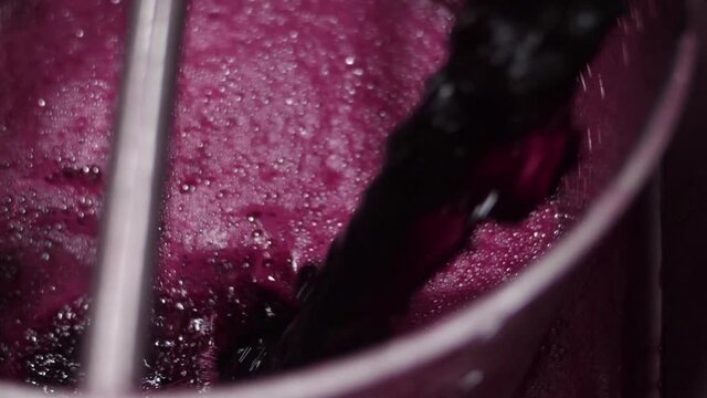 red wine flows out from tap of tank inside a wine cellar prodution slow motion