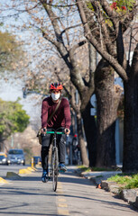 Fototapeta na wymiar Cyclist on a trail bike with a face mask on a sunny day.