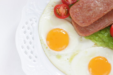 Luncheon meat and sunny side up fried egg for homemade breakfast
