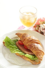 Homemade croissant and luncheon meat sandwich for breakfast