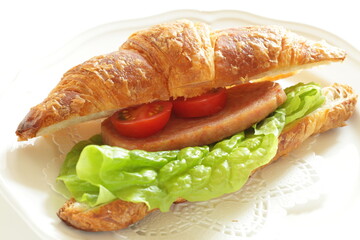Homemade croissant and luncheon meat sandwich for breakfast