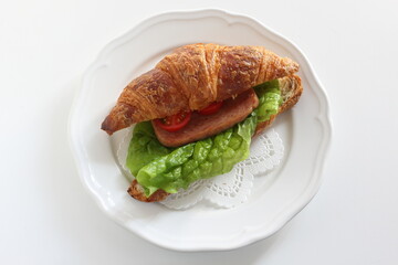 Homemade croissant and luncheon meat sandwich for breakfast