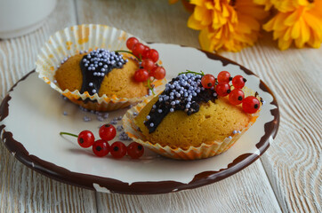 Cupcakes with berries currants, drizzled with chocolate. Fresh homemade cakes