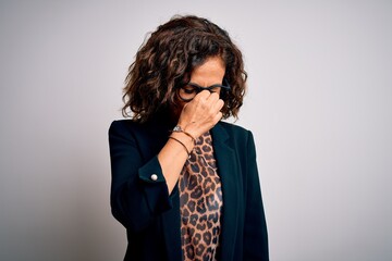 Middle age brunette business woman wearing glasses standing over isolated white background tired...