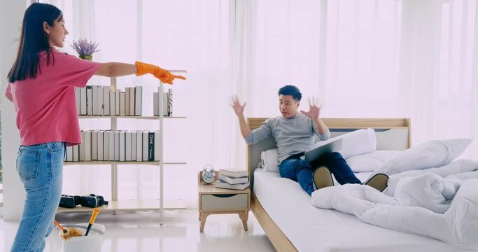 The wife is angry at the husband for making the room messy.