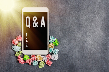 Text sign showing Q And A. Business photo showcasing in which an individual asks questions and another one to answers them Paper accesories with digital smartphone arranged on different background