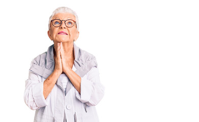 Senior beautiful woman with blue eyes and grey hair wearing casual clothes and glasses begging and...