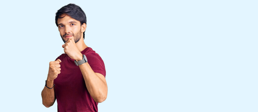 Handsome hispanic man wearing casual clothes ready to fight with fist defense gesture, angry and upset face, afraid of problem