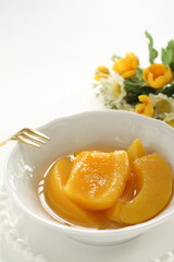 Canned food, mango and syrup in white bowl