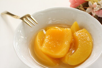 Canned food, mango and syrup in white bowl