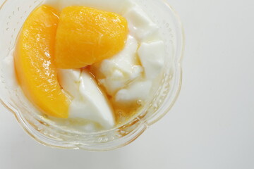 Canned food, mango and syrup in white bowl