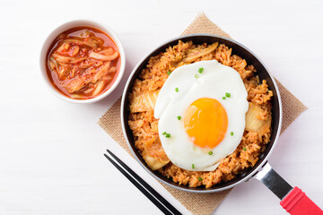Kimchi fried rice with fried egg in small cooking pan and chopsticks ready to eating, Korean food