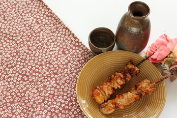 Japanese food, grilled chicken with bamboo skewer on white background