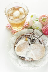 Chocolate cake on dish with iced tea on white background
