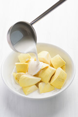 Thai dessert, sliced durian fruit in a bowl eating with coconut milk