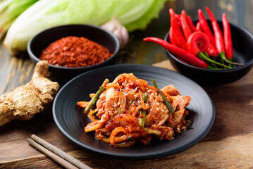 Kimchi cabbage with ingredients on wooden table, Korean food - obrazy, fototapety, plakaty