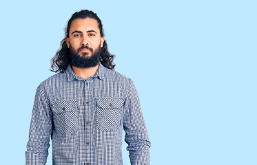 Young arab man wearing casual clothes relaxed with serious expression on face. simple and natural looking at the camera.