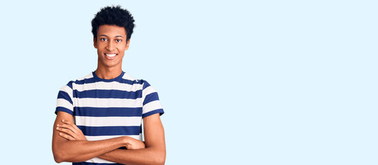 Young african american man wearing casual clothes happy face smiling with crossed arms looking at the camera. positive person.