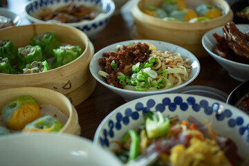 A view of several Chinese dishes laid out on a restaurant or kitchen table.