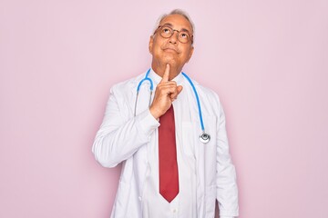 Middle age senior grey-haired doctor man wearing stethoscope and professional medical coat Thinking...