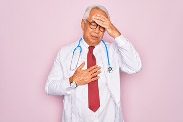 Middle age senior grey-haired doctor man wearing stethoscope and professional medical coat Touching forehead for illness and fever, flu and cold, virus sick