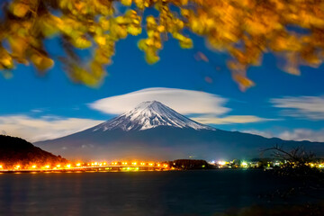 Japan. Evening lights of the city at the foot of mount Fuji. Five lakes of Fuji. The town of Fujikawaguchiko on the lake. Autumn landscape of Japan. The mountain is a symbol of Japan.