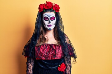 Young woman wearing day of the dead costume over yellow with a happy and cool smile on face. lucky person.