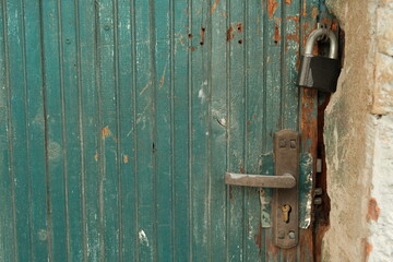 Textured grungy old green door background