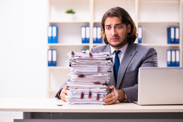 Young male employee and too many cockroaches in the office