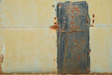 Closeup metal door with lock in grungy style and good texture.