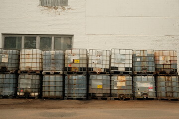 White plastic barrel. Barrel on a pallet with a metal frame. Shipment of chemicals. Plastic container for liquids.
