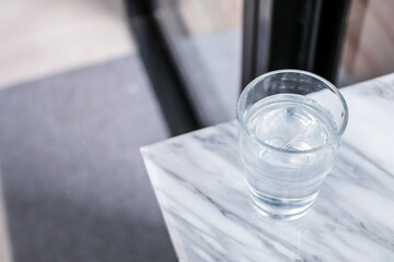 Glass of purified fresh drink water on marble table in cafe or coffee shop.Concept: nature, purification, freshness.