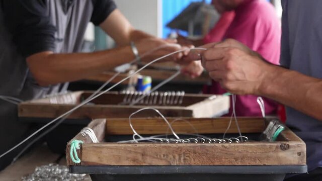 fishermen preparing fishing hooks slow motion