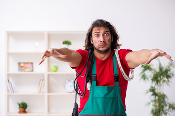 Funny young male electrician working indoors