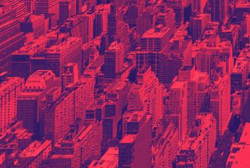 Overhead view of the crowded buildings of Midtown Manhattan in New York City with red and blue...