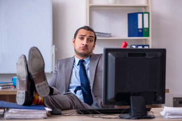 Young male businessman employee working in the office