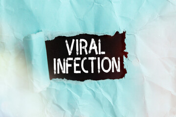 Handwriting text Viral Infection. Conceptual photo Specific attack of the cells from the reproduction of harmful virus Rolled ripped torn cardboard placed above a wooden classic table backdrop