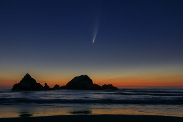 Comet Neowise at sunset over off-shore rock formations