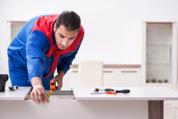 Young male carpenter working indoors