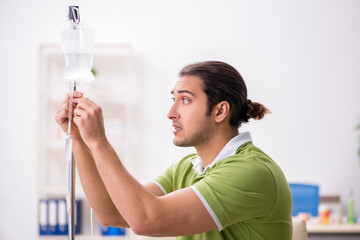 Young male patient in blood transfusion concept