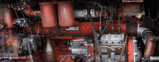 Gordijnen old diesel tractor engine close-up panorama, red and rusty © Vladimir Razgulyaev