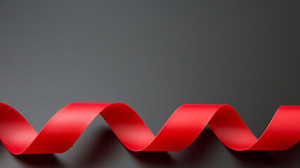 Spiral red ribbon  on a black background and copy space